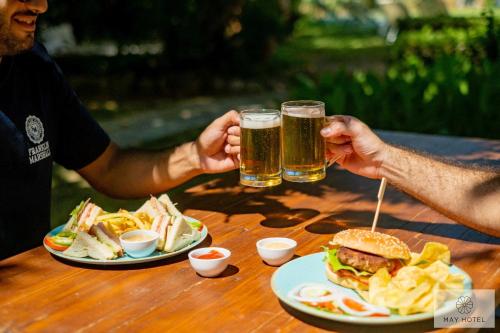 two people sitting at a table with two glasses of beer at May Beach Hotel in Rethymno Town