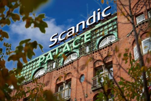 
a building with a clock on the front of it at Scandic Palace Hotel in Copenhagen
