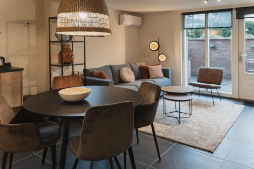 - un salon avec une table et un canapé dans l'établissement Vakantie-appartement Oppe Donck met sauna, à Posterholt