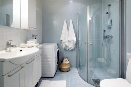 a bathroom with a shower and a sink and a toilet at High-end, quiet, downtown home in Helsinki