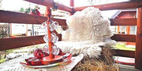 a stuffed teddy bear sitting on a table with a tea pot at Holiday Home Captain's Village in Šljivovica