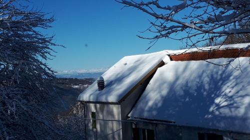 a roof of a house with snow on it at Cascina Marasca Appartamento Viola in Martina Olba
