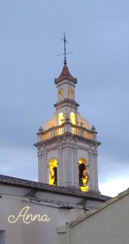a tower with a cross on top of a building at PALACIO Boutique in Anna