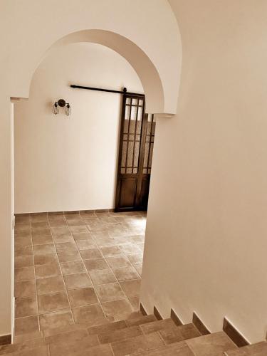 a hallway with a door and a tile floor at PALACIO Boutique in Anna