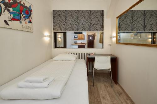 a small room with a bed and a desk at Reykjavik Downtown Hotel in Reykjav&iacute;k