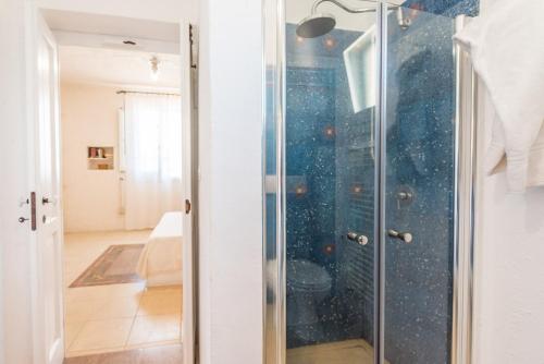 a glass shower door in a room at Trilocale 101-tia Maria Country Inn in Racale