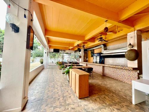 a restaurant with yellow ceilings and a long corridor at MANGO Lagoon Place in Bangkok