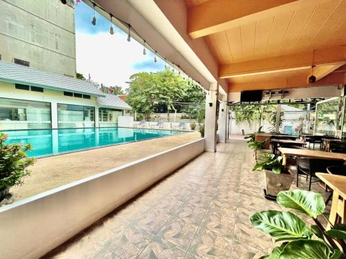 an outdoor patio with a swimming pool on a building at MANGO Lagoon Place in Bangkok