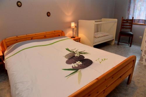 a bedroom with a bed with two rocks on it at Gîtes de Chevémont in Plombières