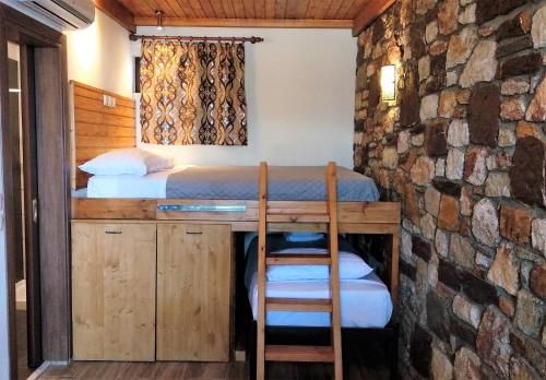 a bedroom with a bed and a desk with two chairs at Rustic House in Émbonas