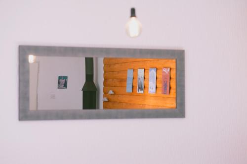 a mirror hanging on a wall in a room at Cabin & Apartment Kopaonik in Kopaonik