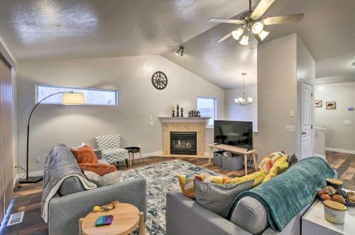 a living room with two couches and a fireplace at Cozy Anchorage Townhome Less Than Half Mile to Jewel Lake! in Anchorage