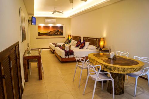 a living room with a bed and a table and chairs at Hotel Azul Maya in Isla Mujeres