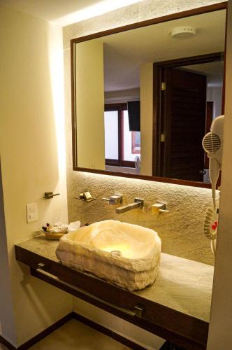 a bathroom with a sink with a large mirror at Hotel Azul Maya in Isla Mujeres