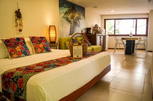 a bedroom with a bed with a basket on it at Hotel Azul Maya in Isla Mujeres