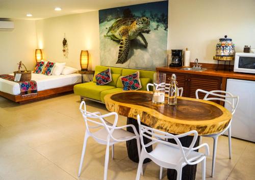 a living room filled with furniture and a table at Casa Azul Maya in Isla Mujeres
