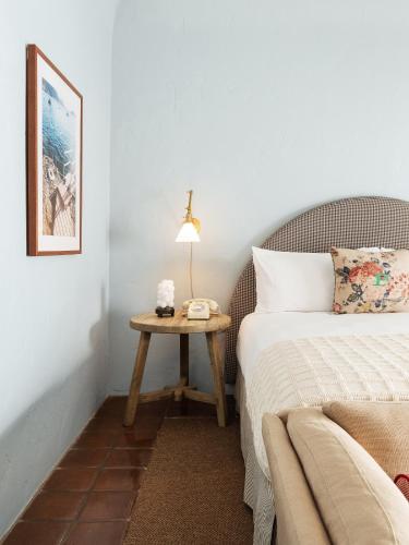 a bedroom with a bed and a table at Palihouse Santa Barbara in Santa Barbara