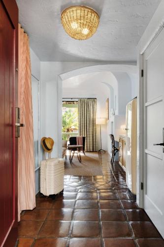 a hallway with a living room with a table at Palihouse Santa Barbara in Santa Barbara