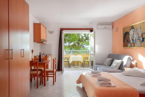 a bedroom with a bed and a dining room with a table at Promenada - Beachfront Apartments in Tučepi