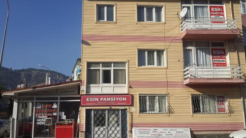 a wooden building with a sign in front of it at Esin Pansiyon in Tokat