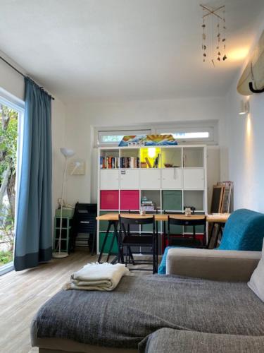 a living room with a couch and a desk at GetWet Surfcamp in Costa da Caparica