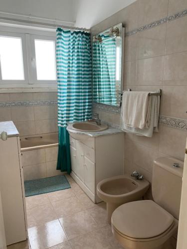 a bathroom with a toilet and a sink and a shower at GetWet Surfcamp in Costa da Caparica