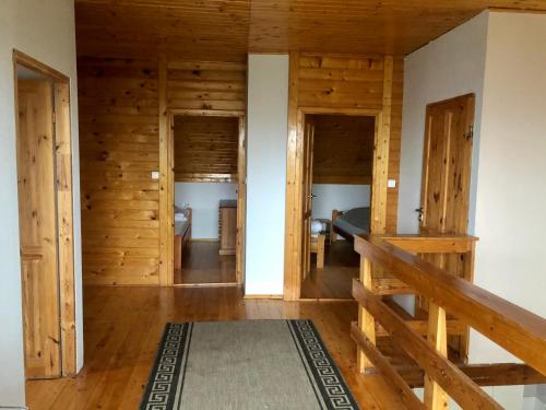 a room with wooden walls and a bed and a staircase at Wigierska Osada 1 in Danowskie