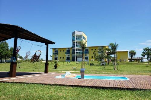 a park with a playground with a slide at Hotel Pousada Laguna Rosa in Barra de Ibiraquera