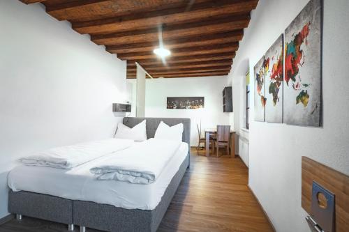 a bedroom with two beds and a table in it at Basic Apartments downtown in Innsbruck