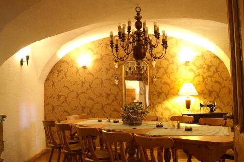 a dining room with a table and a mirror at Landhaus Krone in Steinach