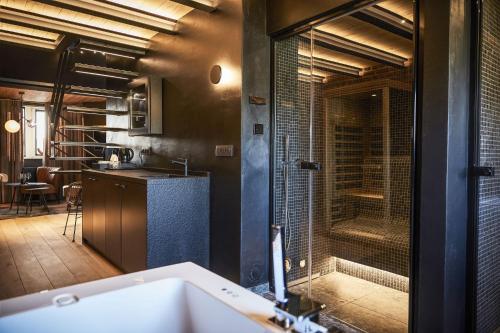 a bathroom with a shower and a sink and a tub at ONIRO - Luxury Rooms & Wellness Suites in Tournai
