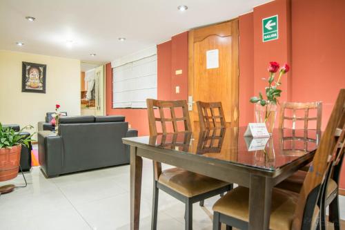 a dining room with a table and chairs at Apart Hotel Incamin in Arequipa