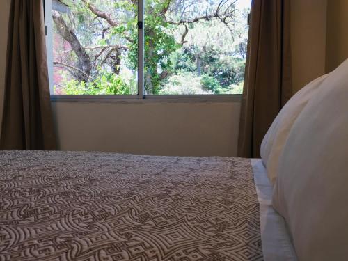 Ένα ή περισσότερα κρεβάτια σε δωμάτιο στο San Remo Punta Hotel