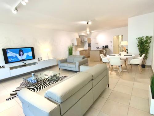 a living room with a couch and a table at Luxury Suite Koksijde 201 - Adult Only in Koksijde