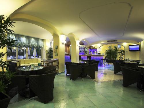 a restaurant with tables and chairs and a bar at Hotel Terme Park Imperial in Ischia