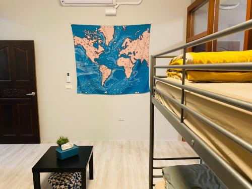 a room with a bunk bed and a map on the wall at 綠色的日子 in Nantou City
