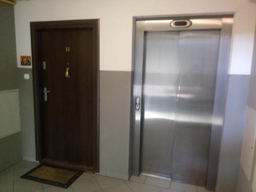 a metal elevator with a door in a room at Chata Mego Brata in Limanowa