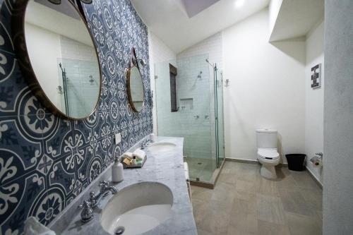 a bathroom with a sink and a mirror at Villa Toscana ValQuirico Lofts & Suites Hotel Boutique in Santeagueda