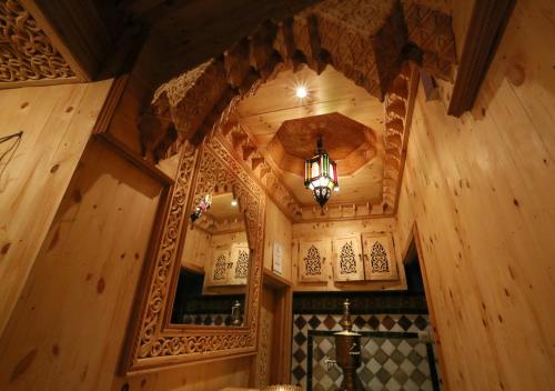 a room with a wooden ceiling and a mirror at Riad Hiba in Meknès
