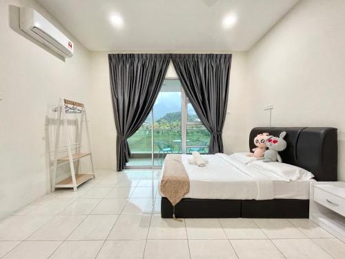 a bedroom with a bed with two stuffed animals on it at Langkawi Cozy Holiday Home at Desa Impian by Zervin in Kuah