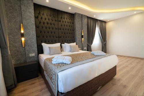 a bedroom with a large bed with blue towels on it at The Green Park Diyarbakir in Diyarbakır