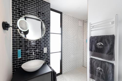 a bathroom with a sink and a mirror at Ferienwohnung PARADIES am Tegernsee in Bad Wiessee