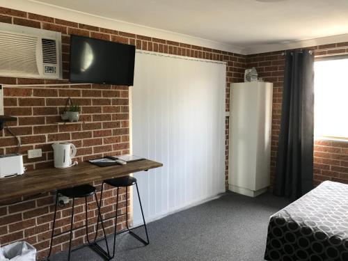 TV a/nebo společenská místnost v ubytování Coffs Shearwater Motel