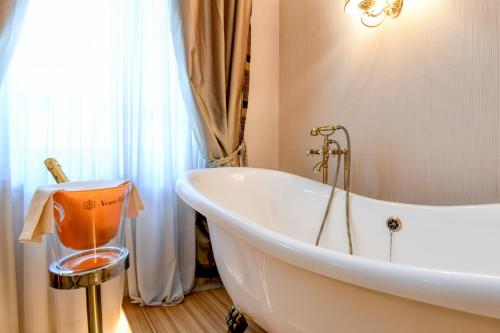 a white bath tub in a bathroom with a window at Hotel Master in Brescia