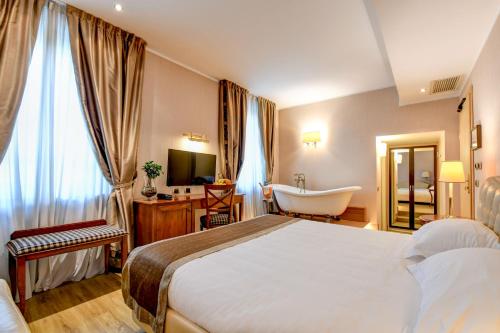 a hotel room with a bed and a bath tub at Hotel Master in Brescia