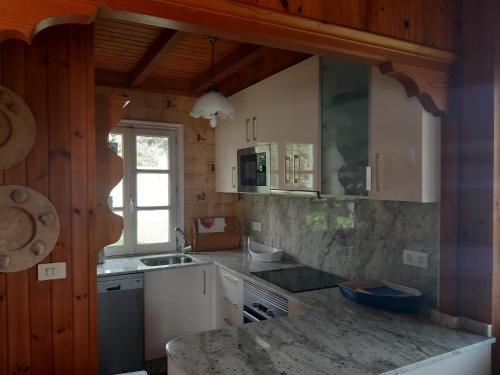 a kitchen with a sink and a counter top at Casa de Madera Sobre el Mar in Nigrán