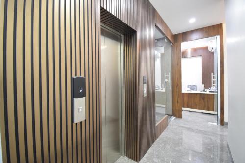 a hallway with a glass door to a building at Hotel Blue Bells in Indore