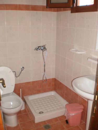 a bathroom with a toilet and a sink at elenis village in Achladies