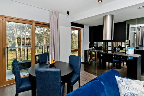 a living room with a blue couch and a table at BlueApart Verano Residence in Jurata