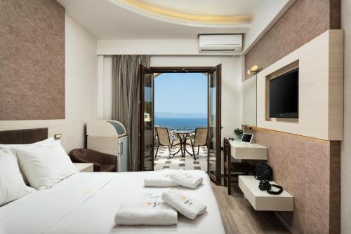 a hotel room with a bed and a view of the ocean at Royal Sun in Chania Town